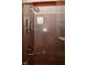Modern shower featuring a rainfall shower head, built-in soap dispensers, and glass door at 5135 Moller Rd, Indianapolis, IN 46254