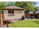 Backyard with green grass, wooden fence, patio furniture, and a wooden hot tub at 517 Bernard Ave, Indianapolis, IN 46208