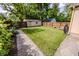 Large, well-maintained backyard with a storage shed, wood fence, and a stone paver patio at 517 Bernard Ave, Indianapolis, IN 46208