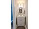 Cozy bathroom with a white vanity, decorative round mirror, and stylish lighting at 517 Bernard Ave, Indianapolis, IN 46208