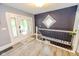 Bright entryway featuring wood floors, a staircase, and a decorative window for added charm at 517 Bernard Ave, Indianapolis, IN 46208