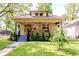 Inviting home featuring a well-manicured lawn, cozy front porch swing, and lovely curb appeal at 517 Bernard Ave, Indianapolis, IN 46208