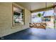 Quaint front porch featuring a wooden swing, decorative window, and serene outdoor space at 517 Bernard Ave, Indianapolis, IN 46208