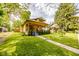 Charming home with a well-manicured front lawn, lovely landscaping, and a welcoming porch at 517 Bernard Ave, Indianapolis, IN 46208
