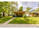 Beautiful home with a manicured lawn, inviting front porch, and a lovely garden at 517 Bernard Ave, Indianapolis, IN 46208