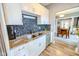 Modern kitchen featuring stainless steel appliances, granite countertops, and white cabinetry at 517 Bernard Ave, Indianapolis, IN 46208