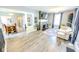 Open-concept living room with stylish flooring, a cozy fireplace, and plenty of natural light at 517 Bernard Ave, Indianapolis, IN 46208