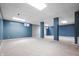 Finished basement with carpeted floors, blue accent walls, and recessed lighting throughout at 5313 Redbird Dr, Columbus, IN 47201