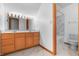 Bathroom showcasing a double sink vanity, and a toilet and shower with stylish white marble surround at 5313 Redbird Dr, Columbus, IN 47201