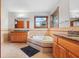 Bathroom with double vanities, tile floors, corner tub and a window at 5313 Redbird Dr, Columbus, IN 47201