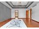 Open bedroom with view into the bathroom featuring a trey ceiling and wood floors at 5313 Redbird Dr, Columbus, IN 47201