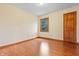 Bedroom featuring wood floors, a window and door at 5313 Redbird Dr, Columbus, IN 47201