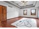 Bedroom showcasing a trey ceiling, wood floors, windows and a decorative rug at 5313 Redbird Dr, Columbus, IN 47201