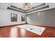 Spacious bedroom featuring a trey ceiling, two windows, hardwood floors and designer rug at 5313 Redbird Dr, Columbus, IN 47201