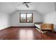 Bright bedroom with hardwood floors, and a window that provides ample natural light and scenic views at 5313 Redbird Dr, Columbus, IN 47201