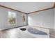 Spacious bedroom featuring hardwood flooring, neutral paint, and bright windows at 5313 Redbird Dr, Columbus, IN 47201