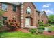 A well-maintained two-story brick home with a landscaped front yard and inviting walkway at 5313 Redbird Dr, Columbus, IN 47201