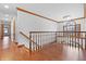 Open foyer with wood flooring, a chandelier, staircase, and arched window at 5313 Redbird Dr, Columbus, IN 47201