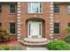 Close-up of the brick facade, front door, and carefully landscaped yard at 5313 Redbird Dr, Columbus, IN 47201