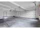 Spacious two car garage with painted walls, concrete flooring and two garage doors at 5313 Redbird Dr, Columbus, IN 47201