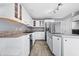 Well-lit kitchen with white cabinets, granite countertops, stainless steel fridge, and an island at 5313 Redbird Dr, Columbus, IN 47201