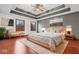 Tranquil main bedroom featuring tray ceiling, hardwood floors, two windows and stylish décor at 5313 Redbird Dr, Columbus, IN 47201