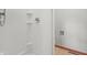 Close up of a simple walk-in shower with tile floors and bright, white walls at 5313 Redbird Dr, Columbus, IN 47201