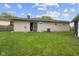Backyard view of home with door opening onto grass at 5326 Brazos Dr, Indianapolis, IN 46237