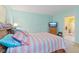 A spacious carpeted bedroom features a large bed, a TV, and an adjoining laundry room at 5326 Brazos Dr, Indianapolis, IN 46237