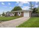 A brick ranch home featuring an attached garage, manicured lawn and mature trees at 5326 Brazos Dr, Indianapolis, IN 46237