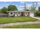 Charming brick home with a well-manicured lawn, attached garage, and inviting front entrance at 5326 Brazos Dr, Indianapolis, IN 46237