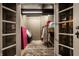 Basement closet with exposed concrete block walls and a vintage looking door at 5401 N New Jersey St, Indianapolis, IN 46220