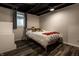 Small bedroom with hardwood floors, white walls, and a bed with a decorative tiger at 5401 N New Jersey St, Indianapolis, IN 46220