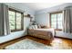 Cozy bedroom featuring hardwood floors, natural light, and a comfortable bed at 5401 N New Jersey St, Indianapolis, IN 46220