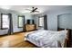 Bright bedroom with large windows, hardwood floors, ceiling fan, and a neutral color scheme at 5401 N New Jersey St, Indianapolis, IN 46220