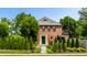 Charming brick home with a well-manicured lawn and stone walkway leading to a green front door at 5401 N New Jersey St, Indianapolis, IN 46220