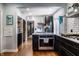 Charming kitchen featuring black cabinetry, stainless steel appliances, and hardwood flooring at 5401 N New Jersey St, Indianapolis, IN 46220
