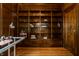 Office space featuring wood paneling, built-in bookshelves, hardwood floors, and a glass desk at 5401 N New Jersey St, Indianapolis, IN 46220