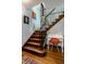 Elegant wooden staircase with iron railings, complemented by a stylish desk and decor at 5401 N New Jersey St, Indianapolis, IN 46220