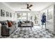 Cozy sunroom featuring a gray couch, decorative tile floor, and lots of light at 5401 N New Jersey St, Indianapolis, IN 46220