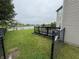 Landscaped backyard with a wooden deck, green lawn, and partial view of the lake at 5502 Floating Leaf Dr, Indianapolis, IN 46237