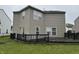 Exterior of home with wooden deck, green lawn, and a vinyl siding at 5502 Floating Leaf Dr, Indianapolis, IN 46237