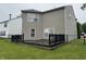 Spacious backyard featuring a wooden deck, a lush green lawn, and a vinyl siding at 5502 Floating Leaf Dr, Indianapolis, IN 46237
