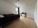 Bright bedroom featuring wood floors, large window and a dedicated desk area at 5502 Floating Leaf Dr, Indianapolis, IN 46237