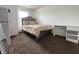 Neutral bedroom with plush carpeting, a comfortable bed, and a modern desk area at 5502 Floating Leaf Dr, Indianapolis, IN 46237