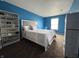 Bedroom features blue walls, white trim and a queen sized bed at 5502 Floating Leaf Dr, Indianapolis, IN 46237