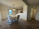 Bright dining room with modern table and chairs, hardwood floors, and backyard access at 5502 Floating Leaf Dr, Indianapolis, IN 46237