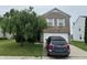 Charming two-story brick home with a well-manicured front yard and attached two-car garage at 5502 Floating Leaf Dr, Indianapolis, IN 46237