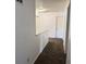 Upstairs hallway of home with white walls and dark brown carpet at 5502 Floating Leaf Dr, Indianapolis, IN 46237