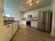 Modern kitchen with stainless steel appliances, lots of cabinet space and wood flooring at 5502 Floating Leaf Dr, Indianapolis, IN 46237